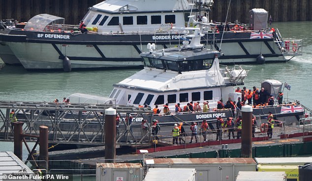Migrants disembark from a Border Force vessel in Dover last week