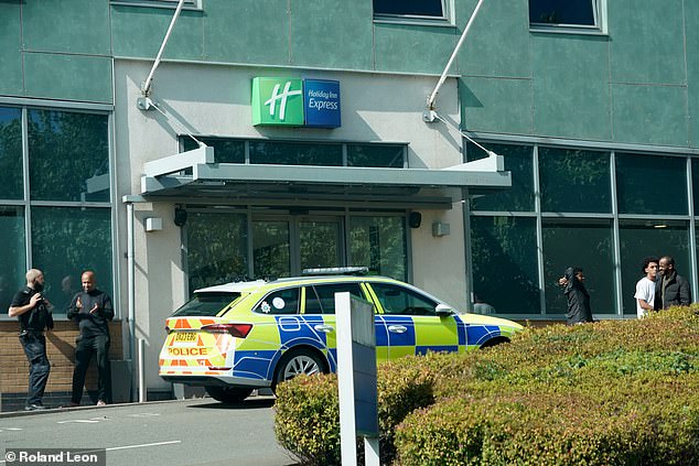 Hundreds of people gathered as a group of masked thugs threw a burning bush inside the side entrance, while onlookers filmed, cheered and clinked their beer bottles