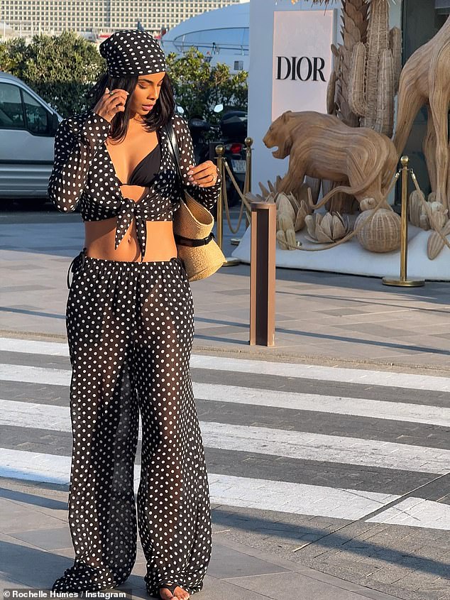 Rochelle also posted a snap flashing her washboard abs in a polka dot beach set on their child-free trip
