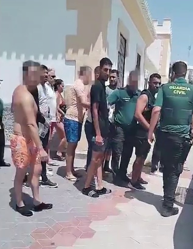 Scenes show how police took away the men believed to be migrants after tourists tackled and detained them