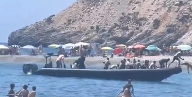 Screen grab shows the moment the men, believed to be migrants, jumped out of the boat and into the sea