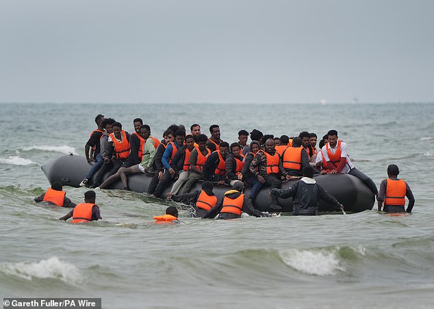 Home Office figures showed there were 43,630 detected irregular arrivals in 2024, of which 84% arrived on small boats. Pictured: People board a small boat near Wimereux, France