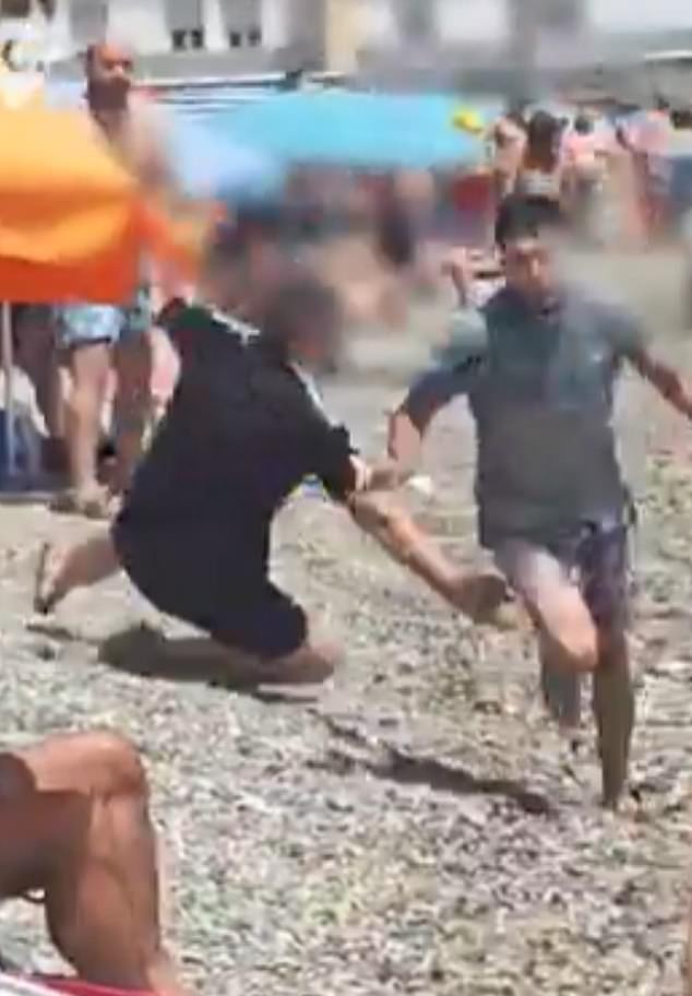 Screengrab shows a man, believed to be a migrant from Morocco, running away from a bather who tries to detain him
