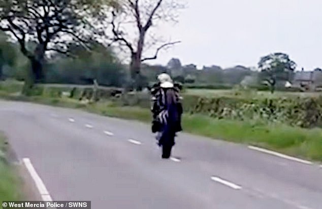 In the hair-raising clip shot around Shrewsbury and Wem, Shropshire, Males can first be seen hurtling along on one wheel as he speeds down a country road