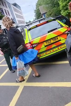 Police escort two drag artists away from Drag Queen Story Time at Holywood Arches Library in Belfast