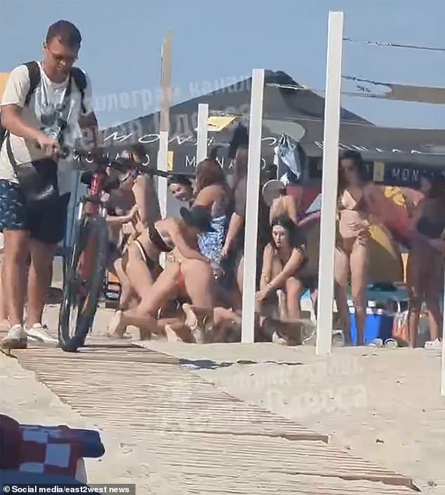 A beach brawl broke out in war-ravaged Odesa when two bikini-clad women clashed and wrestled each other