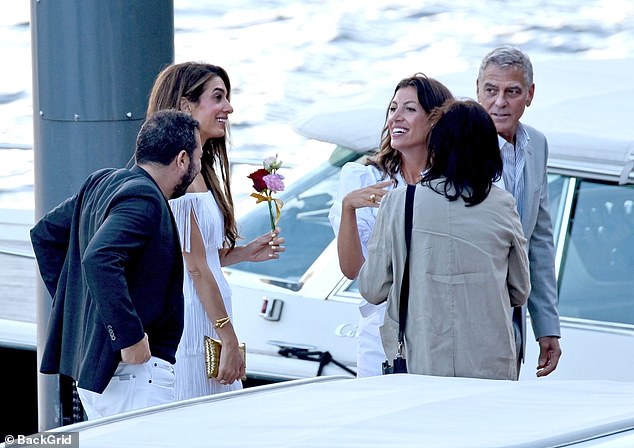 Amal smiled broadly at the other guests