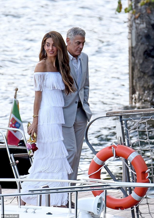 Amal and George walked side by side up the jetty