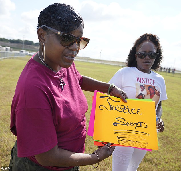 Necoule Davis, left, and Sharonda Page, both cousins of Black's victims, wait outside Riverbend Maximum Security Institution before the killer's execution