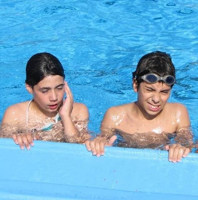 Guy, left, and Evyatar enjoy a swim aged 12. The pair are lifelong friends