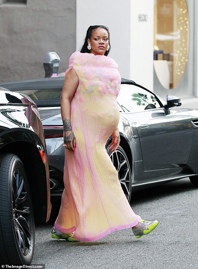 The Fenty mogul donned quite the pricey ensemble for the errand trip as she sported a $2,845 Spring/Summer 2001 Vintage Issey Miyake pink and orange 3D high neckline pleated dress