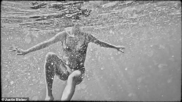 A bikini-clad Hailey also swims through the ocean