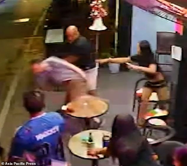 The CCTV footage shows the Thai bar girl hurling a glass at Mr Lilley's face as he hit her with his right fist