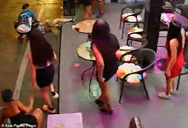 Sureerat can be seen staggering backwards as a male customer pushes Mr Lilley away, causing him to crack his right arm on the pavement