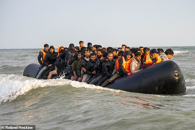 A group of migrants can be seen onboard an inflatable vessel on Wednesday off Gravelines beach in northern France