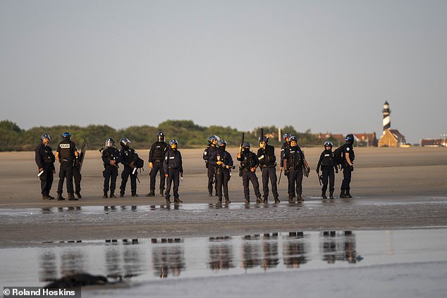 Police helplessly watched as dozens of migrants were picked up by small boat taxis from Gravelines beach in northern France