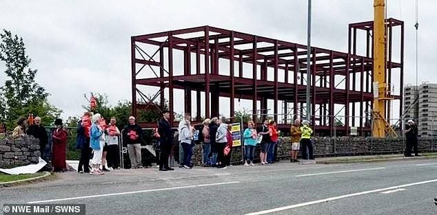 Protesters outside the site, where construction on the mosque has begun after the project got council approval