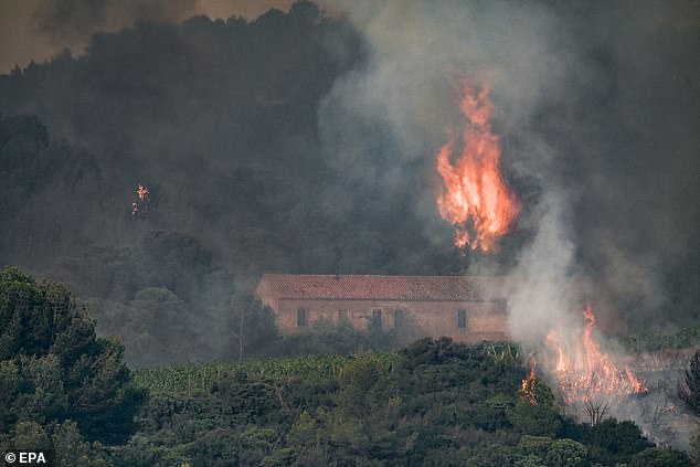 Flames billow from a forest fire near Saint Laurent de la Cabrerisse in Aude, France, 6 August 2025