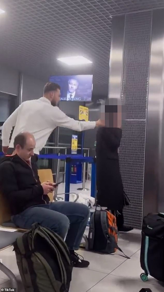 In another clip, the influencers held their phone up against a man and played the Apple Pay sound effect