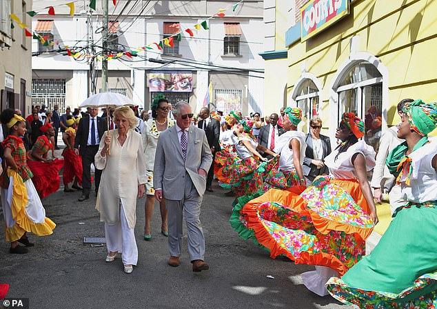 Charles and Camilla are greeted by dancers in Saint George's in Grenada in March 2019