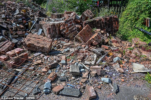 Fury has erupted after the remains of Britain's wonkiest pub were 'left to rot' (pictured) for two years after it was destroyed in a fire