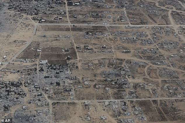 Destroyed buildings in the Gaza Strip are seen from a Jordanian Air Force C-130 plane during an airdrop of humanitarian aid for Palestinians, Thursday, August 7