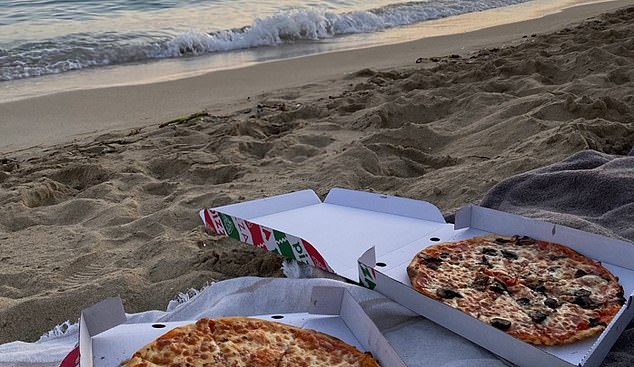Visitors on the island are more likely to look for cut-price takeaway food options that they can take to the beach than dine out, say officials (Pictured: pizzas on a beach in Mallorca)