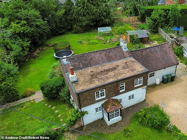 Scientist David Hughes, 63, who lives nearby, said before the development was shut down he hoped he was not a 'NIMBY' for opposing the cottage's (pictured) demolition