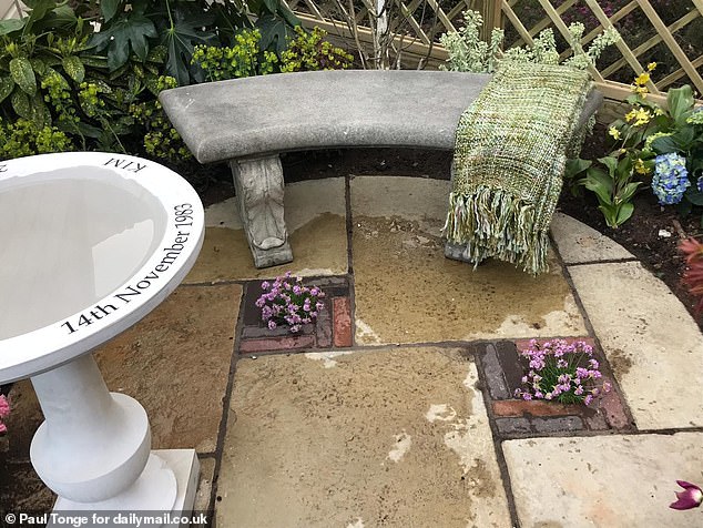 It includes a charming wishing well for Kim and a bench to sit and remember on