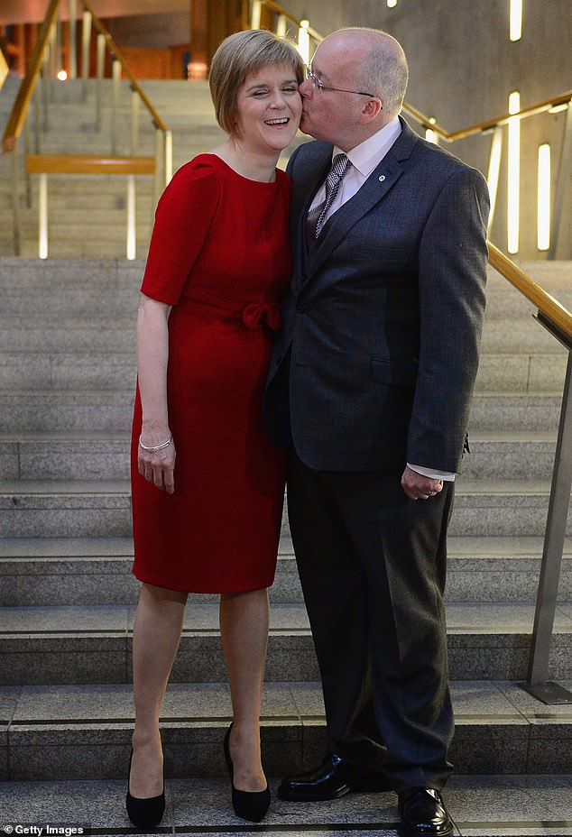 Ms Sturgeon with her husband after being voted in as first minister of Scotland at the Scottish Parliament on November 19, 2014 in Edinburgh