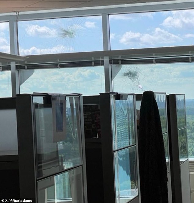 Pictured: Bullet holes are seen in Building 21 at the Centers for Disease Control and Prevention, which is just down the road from Emory College