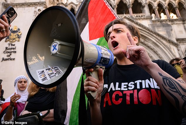 Thousands of police will reportedly be deployed and placed on standby to keep the peace at a series of anti-asylum demonstrations and counter protests. Pictured: A Palestine Action supporter outside the High Court last month following the group's proscription