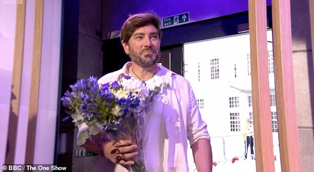 Clearly stunned, Alex looked lost for words as Charlie walked in holding a beautiful bouquet of flowers