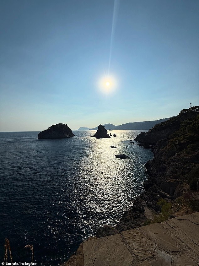 During the daytime, she also snapped and shared a similar photo of the rocks with the sun shining over the ocean