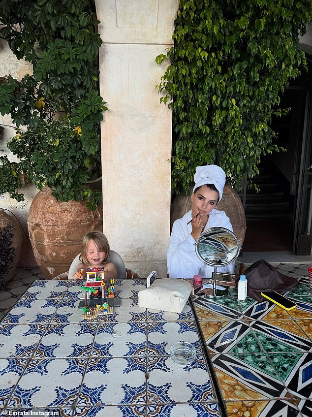 As part of her social media post, she also included one memory of her getting ready, putting on makeup in a robe, while her son sat beside her, playing with legos