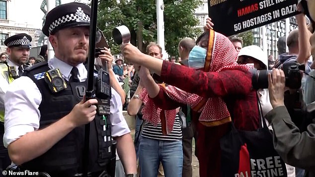 A Metropolitan Police officer has been hailed for having the 'patience of a saint' after a pro-Palestine protester loudly banged a metal pot repeatedly next to his ear