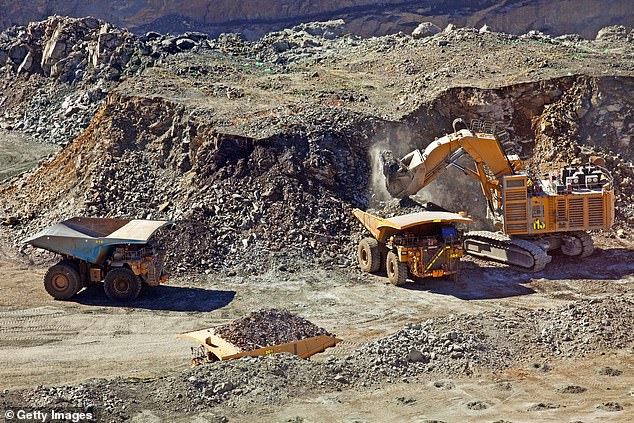 Huge dump trucks ferrying material at an open gold mine in Western Australia