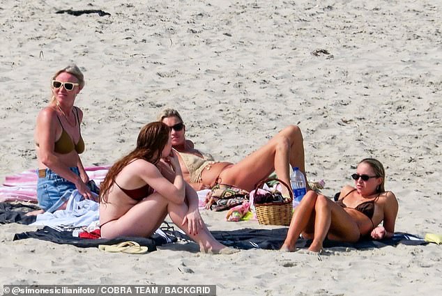 The model was joined by her daughter Lila (far right), and pals Bella Tilbury (second left), who is the niece of makeup mogul Charlotte Tilbury, and fashion designer Luella Bartley (far left)