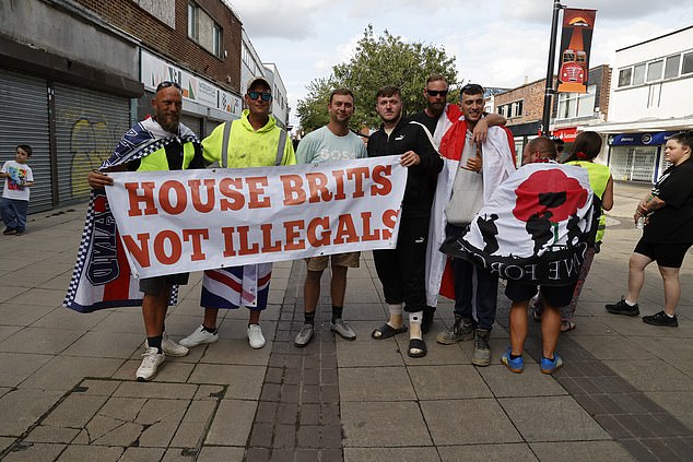 Protesters hold a sign which reads 'House Brits not illegals' during the demonstration on July 30