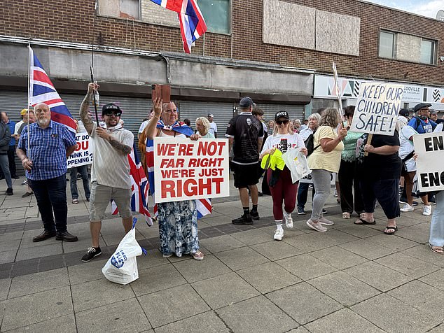 A woman holds a sign which reads 'We're not far right, we're just right' during the demonstration