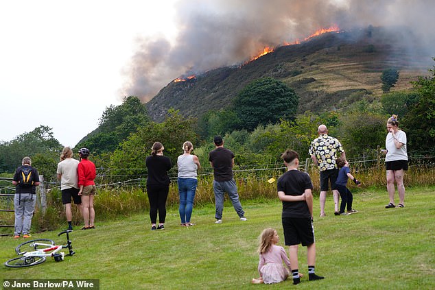 Members of the public watch the fire on Arthur's Seat in Holyrood Park, Edinburgh