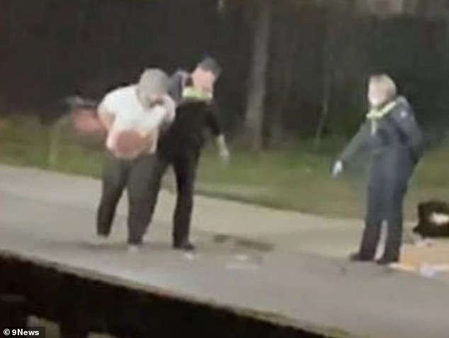 A homeless man, 34, (pictured during his arrest) will appear in court on Wednesday