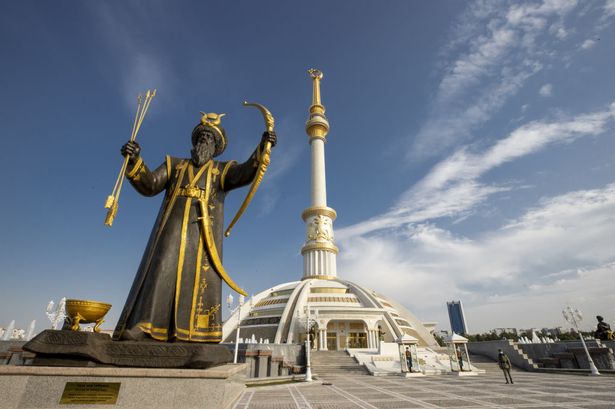 A view of statue of Oguz Han as the Independence Monument stands behind in Ashgabat, Turkmenistan