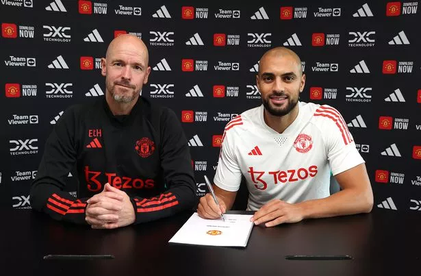 Sofyan Amrabat signs his Manchester United contract with Erik ten Hag