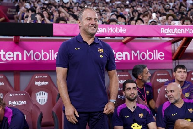 Hansi Flick looks on before the preseason friendly between Vissel Kobe and FC Barcelona at Noevir Stadium Kobe