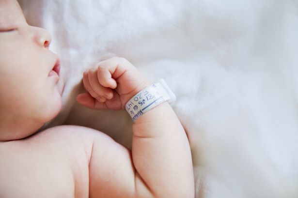 Baby with hospital bracelet