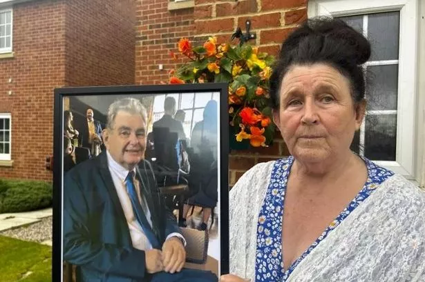 Lauren Williams holding a picture of her late husband 