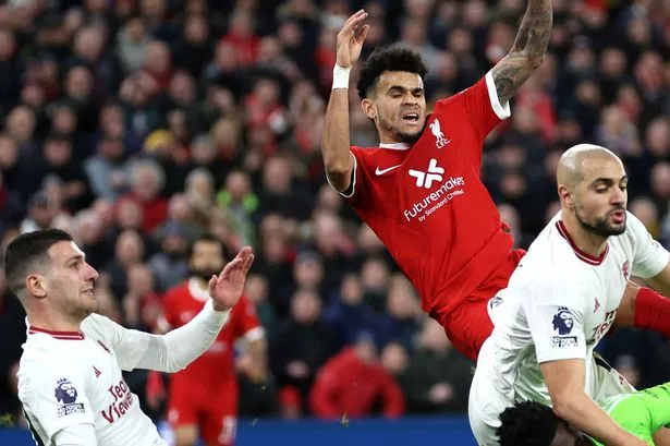 Luis Diaz of Liverpool has a shot blocked by Sofyan Amrabat and Andre Onana