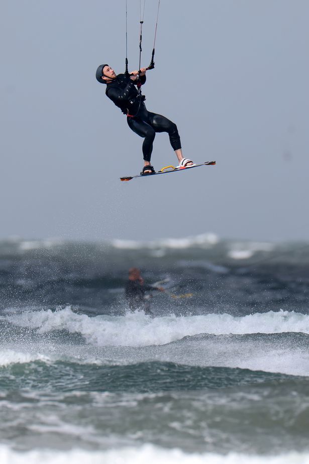 A kite surfer is seen at Troon beach during the storm