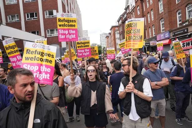 Protesters with Stand Up To Racism gather outside the Thistle City Barbican Hotel in London, which houses asylum seekers.